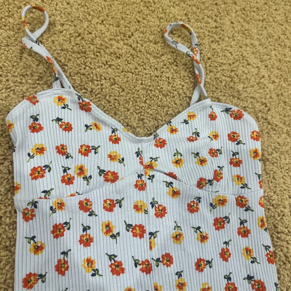 out from under blue floral bodysuit